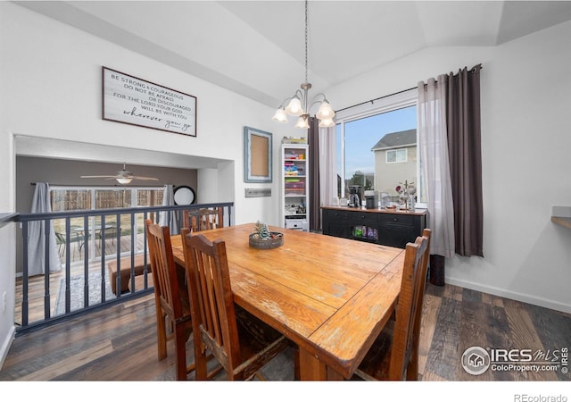 dining room with lofted ceiling, dark hardwood / wood-style flooring, ceiling fan with notable chandelier, and plenty of natural light