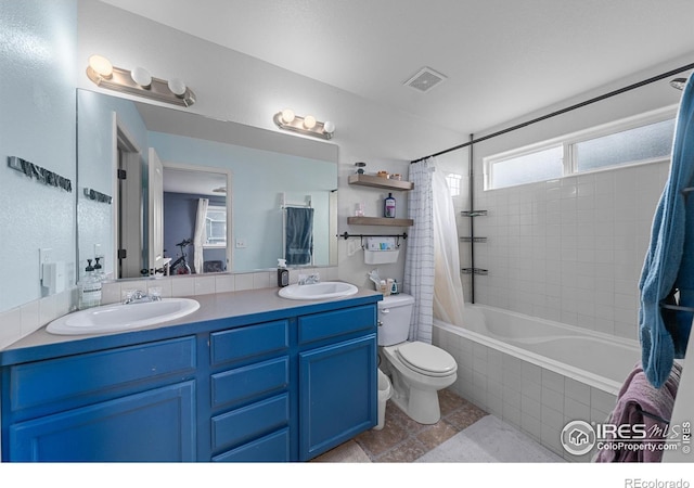 full bathroom featuring toilet, shower / tub combo, and vanity