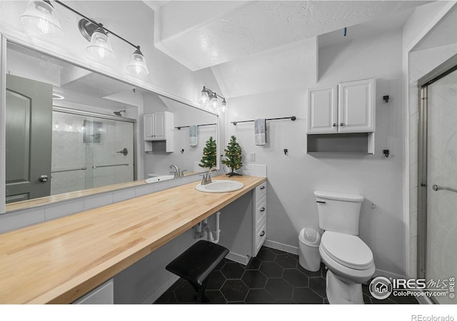 bathroom featuring toilet, tile patterned floors, walk in shower, and lofted ceiling