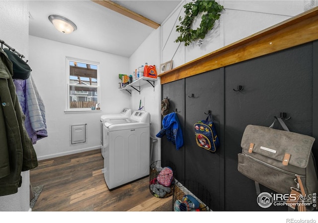 washroom featuring dark hardwood / wood-style flooring and washer and clothes dryer