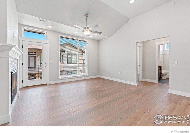 unfurnished living room featuring light hardwood / wood-style floors, lofted ceiling, and ceiling fan