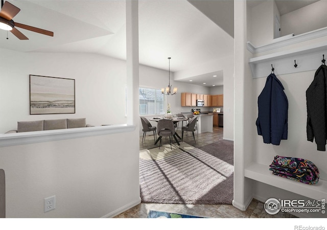 mudroom featuring ceiling fan with notable chandelier, lofted ceiling, and light carpet