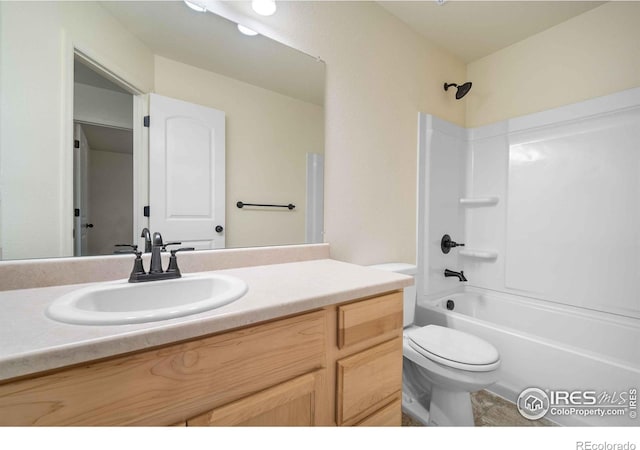 full bathroom featuring toilet, vanity, and tub / shower combination