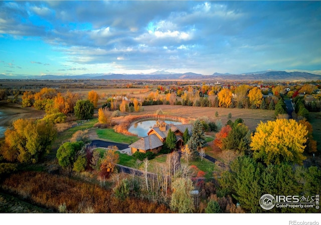 drone / aerial view with a water and mountain view