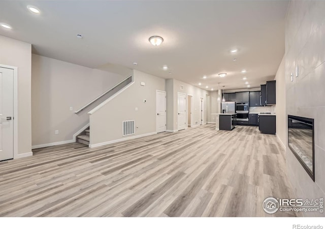 unfurnished living room featuring hardwood / wood-style floors