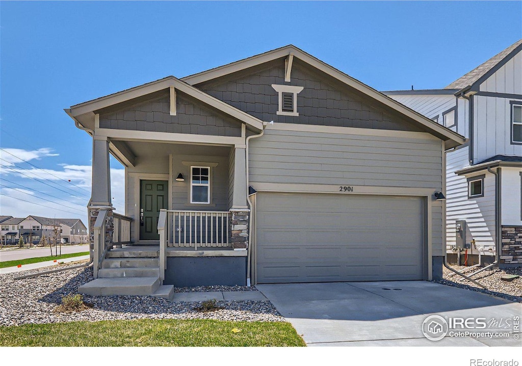 view of front of home with a garage and a porch