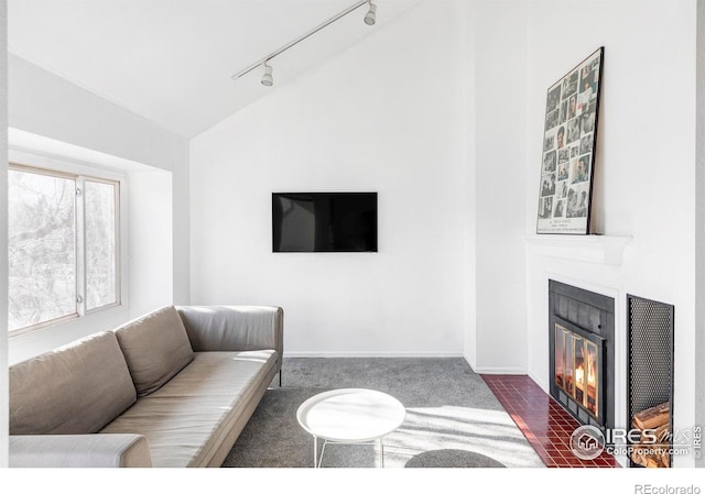 living room with track lighting, vaulted ceiling, and dark carpet