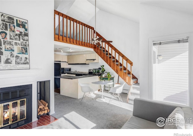 living room featuring lofted ceiling, carpet flooring, and ceiling fan