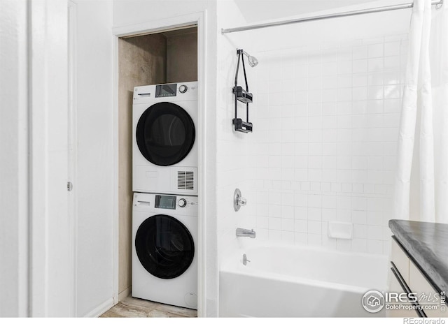 laundry area with stacked washing maching and dryer