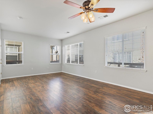 spare room featuring ceiling fan and dark hardwood / wood-style floors