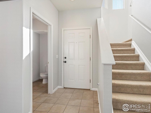 entryway with light tile patterned flooring