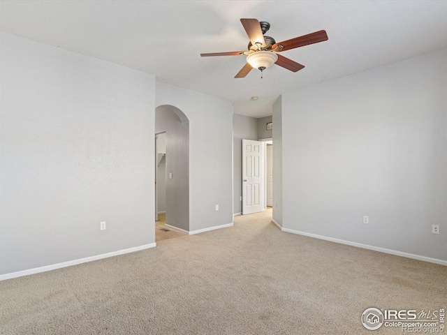 empty room with ceiling fan and light colored carpet