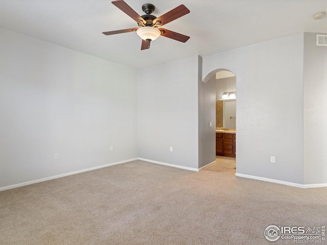 carpeted empty room featuring ceiling fan