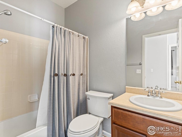 full bathroom with vanity, shower / bath combo with shower curtain, and toilet