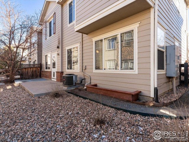 view of side of home featuring central AC and a patio area