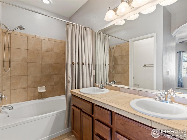 bathroom featuring shower / bathtub combination with curtain and vanity