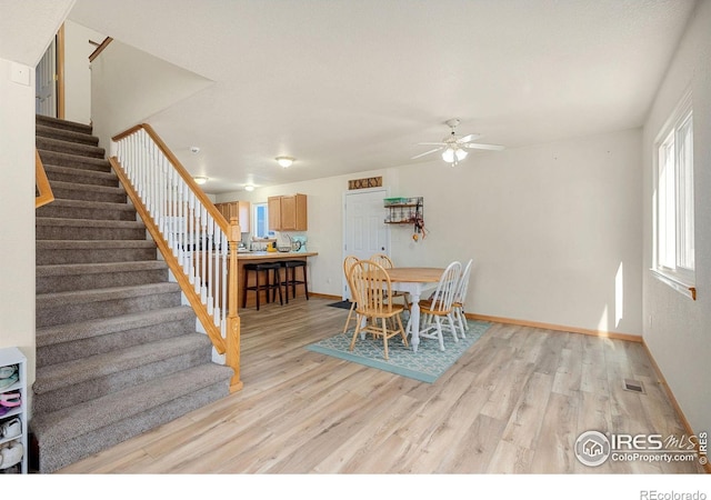 dining space featuring ceiling fan and light hardwood / wood-style flooring