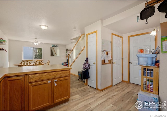 kitchen featuring ceiling fan and light hardwood / wood-style flooring