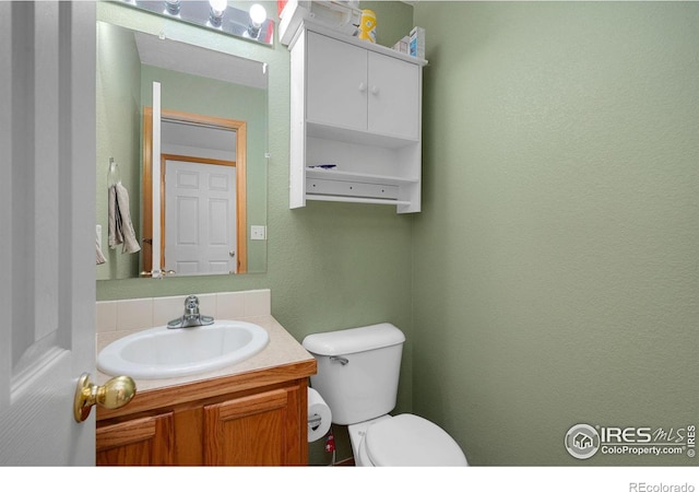 bathroom featuring vanity and toilet