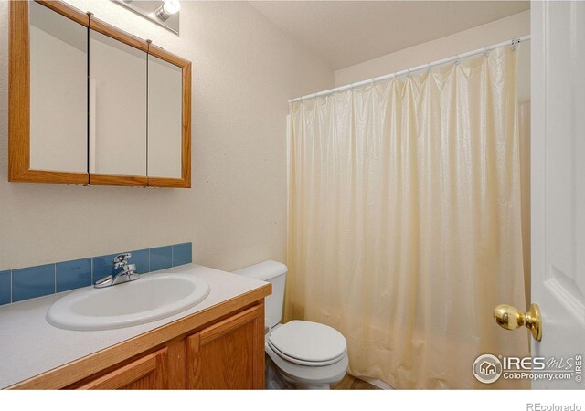 bathroom featuring toilet and vanity