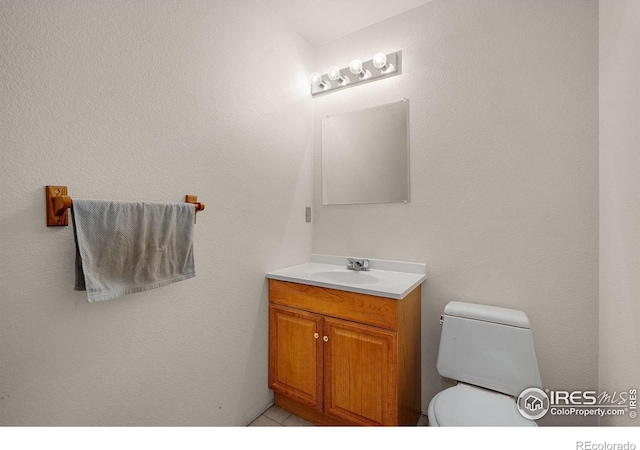 bathroom with toilet and vanity