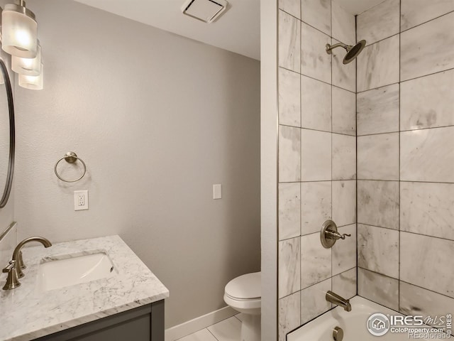 full bathroom featuring vanity, tile patterned flooring, tiled shower / bath combo, and toilet