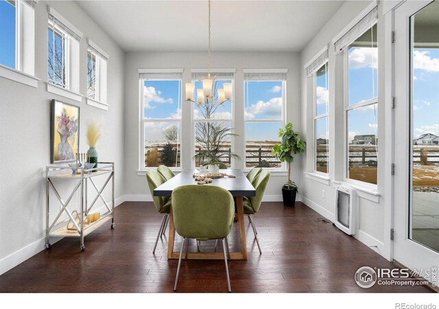 sunroom featuring a healthy amount of sunlight and a chandelier