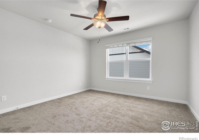 carpeted empty room featuring ceiling fan