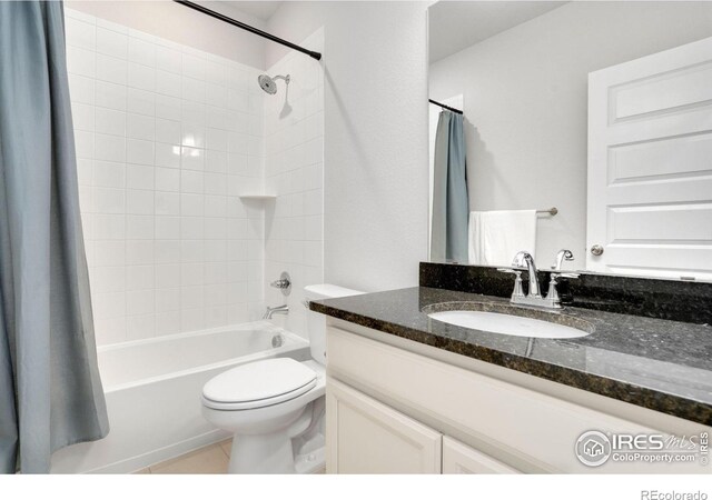 full bathroom featuring toilet, tile patterned flooring, vanity, and shower / tub combo