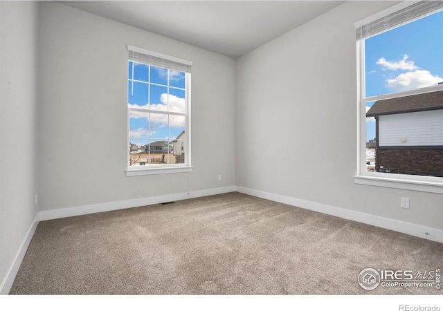 empty room with carpet flooring