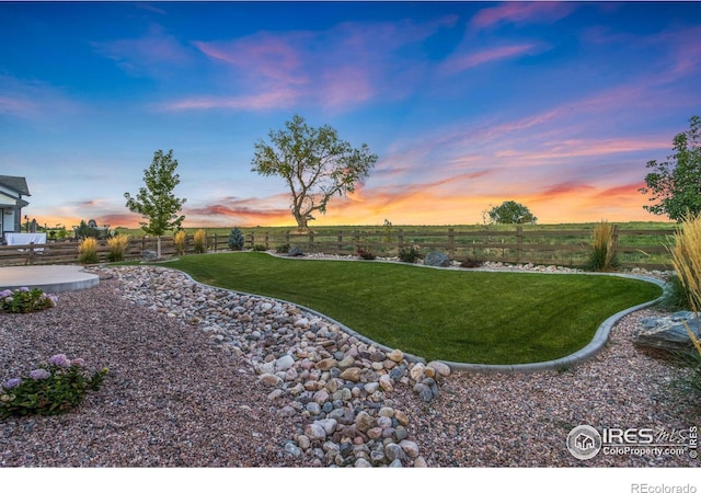 yard at dusk with a patio