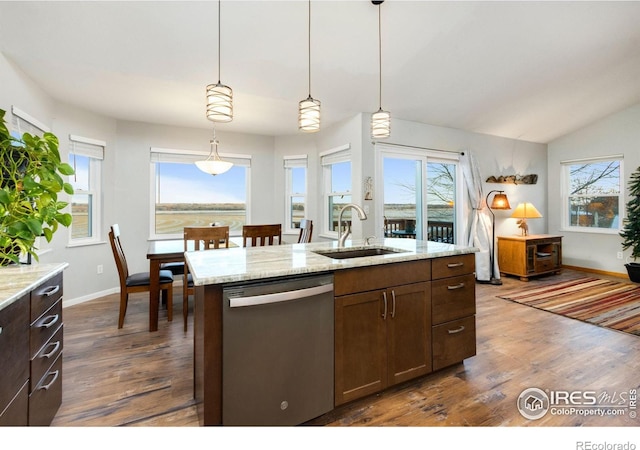 kitchen featuring sink, pendant lighting, dishwasher, and light stone counters