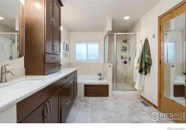 bathroom featuring vanity and separate shower and tub