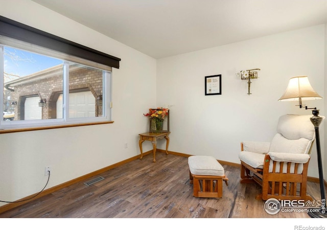 sitting room featuring dark wood-type flooring