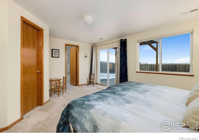 bedroom with access to outside and light colored carpet