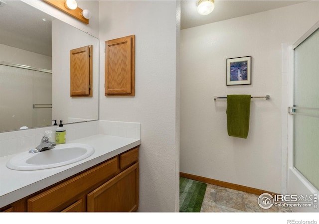 bathroom with walk in shower and vanity