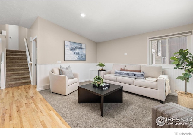 living room with lofted ceiling and hardwood / wood-style flooring