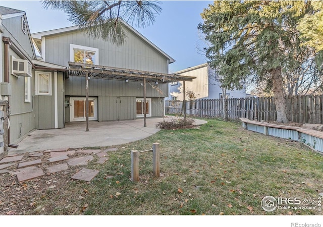 view of yard featuring a wall mounted AC and a patio area