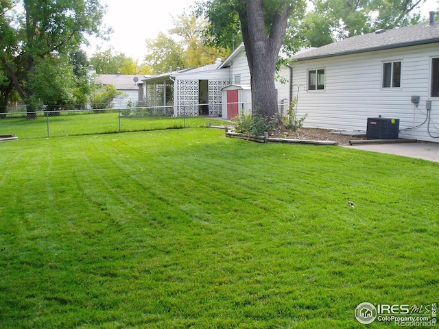 view of yard featuring cooling unit and a patio area