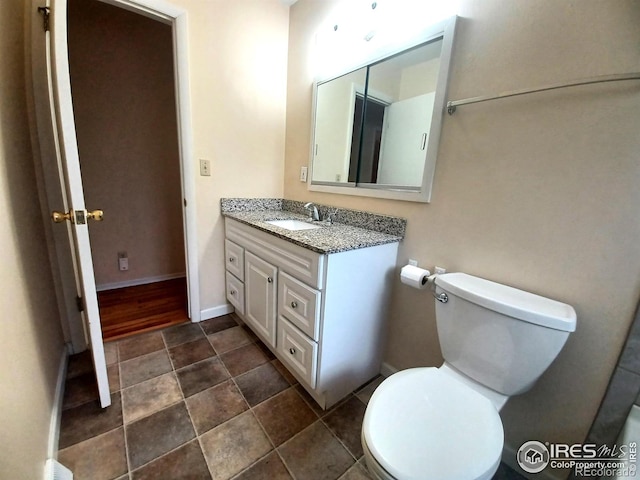 bathroom with toilet and vanity