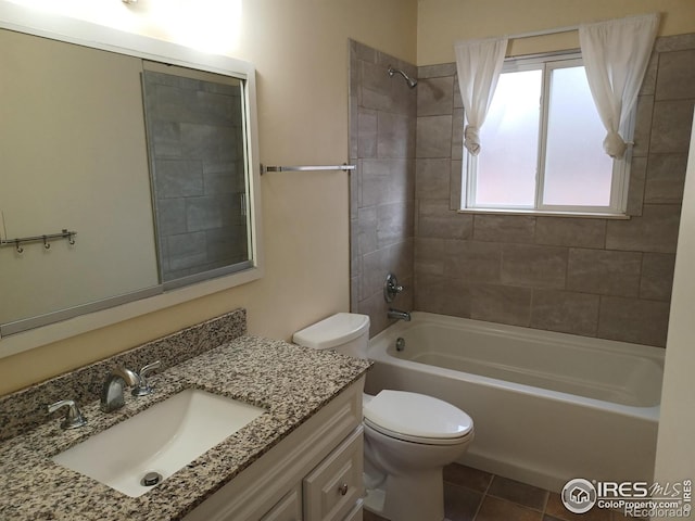 full bathroom featuring vanity, toilet, tile patterned floors, and tiled shower / bath