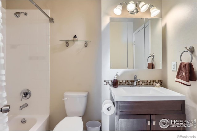 full bathroom with tasteful backsplash, vanity, tiled shower / bath combo, and toilet