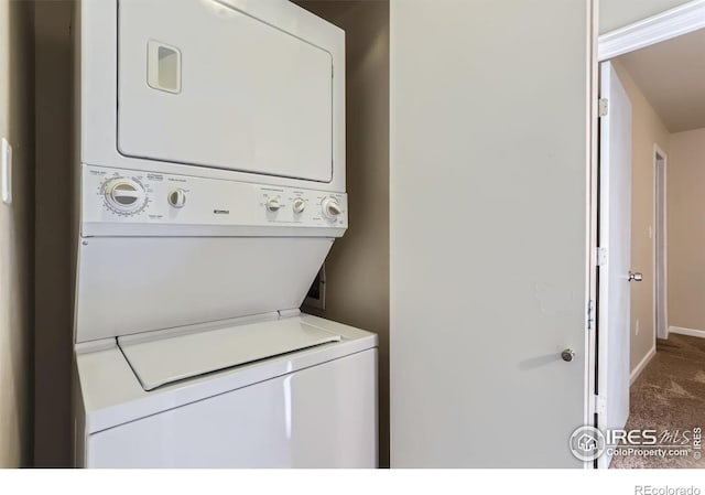 laundry area featuring carpet flooring and stacked washer / dryer