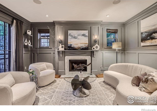 sitting room featuring a premium fireplace and crown molding