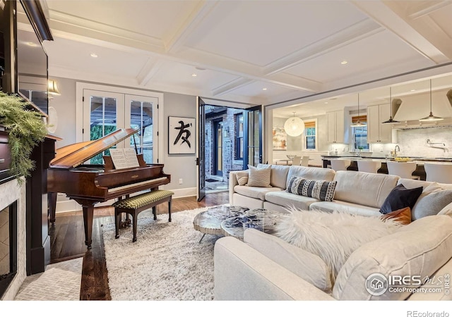 living room with sink, french doors, hardwood / wood-style floors, coffered ceiling, and beam ceiling