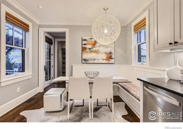 dining room with plenty of natural light, dark wood-type flooring, crown molding, and breakfast area