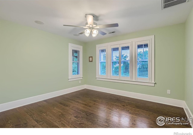 empty room featuring ceiling fan and dark hardwood / wood-style floors