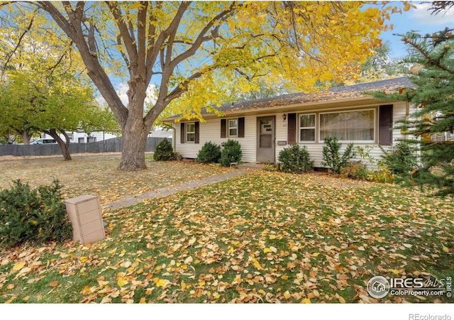 ranch-style home with a front lawn