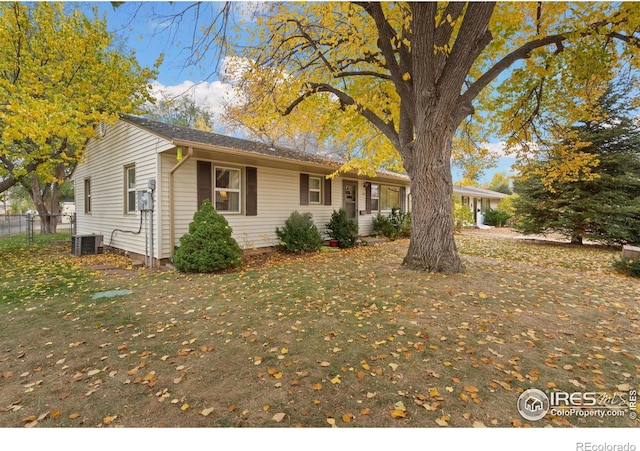 ranch-style house featuring central AC and a front yard