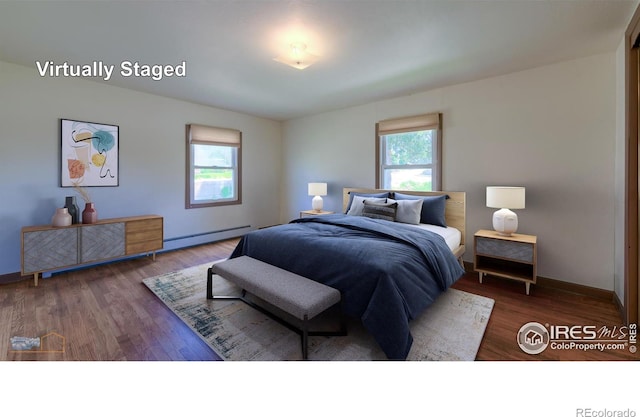 bedroom featuring a baseboard radiator and dark hardwood / wood-style flooring